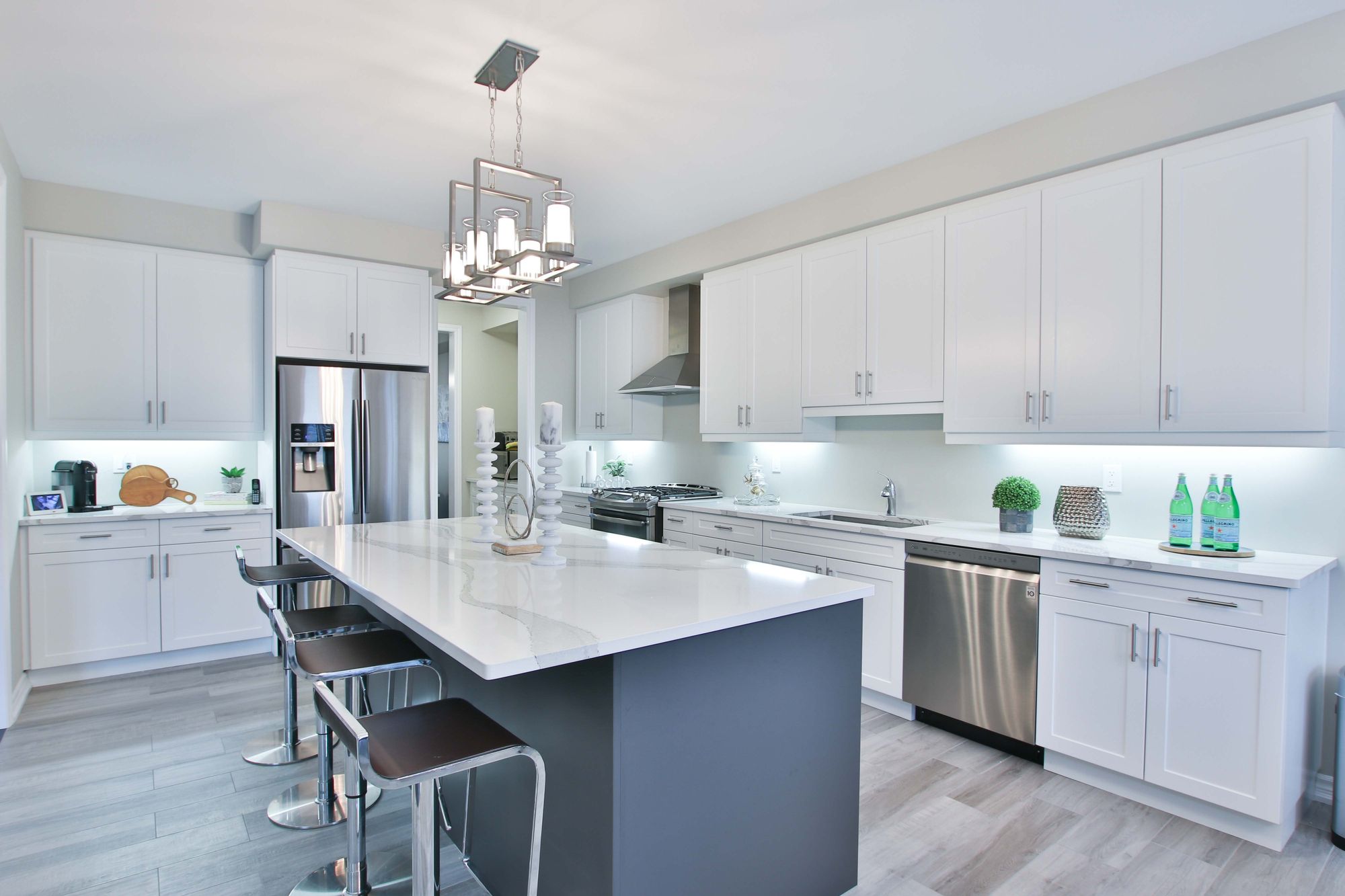 A modern lighting fixture above the kitchen island